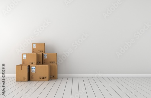 Moving boxes at a new home. White wall and floor