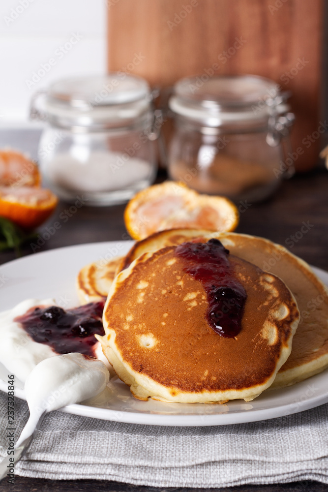pancakes with jam and yogurt on the kitchen table close up. pancakes with jam and yogurt on the kitchen table close up.