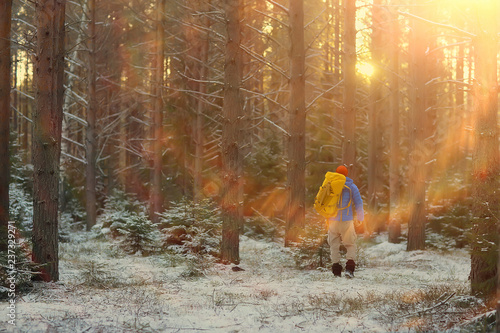 winter landscape forest backpack man / traveler in modern winter clothes in the forest, traveling in the mountains  europe, switzerland winter photo