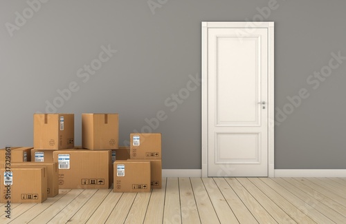 Moving boxes at a new home with door. Apartment, concepts. © abdulkadir
