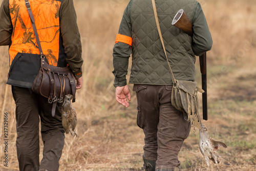 The hunter in the hunting clothes and with rifle hunts photo