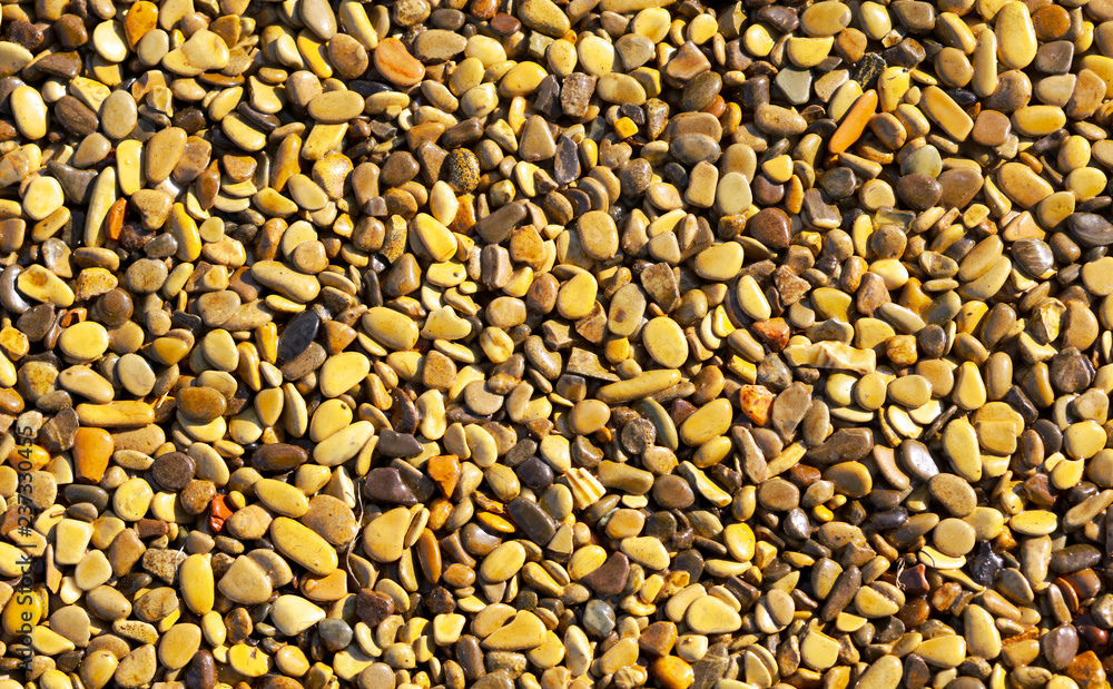 Small yellow stones on the road surface as background Small yellow stones on the road surface as background