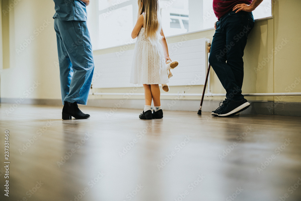 Fototapeta premium Nurse walking a patient down the hallway