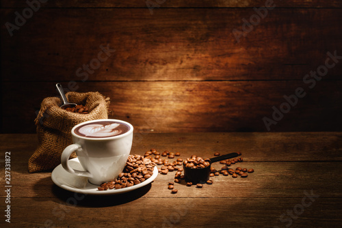 A cup of latte art with roasted coffee bean in bag