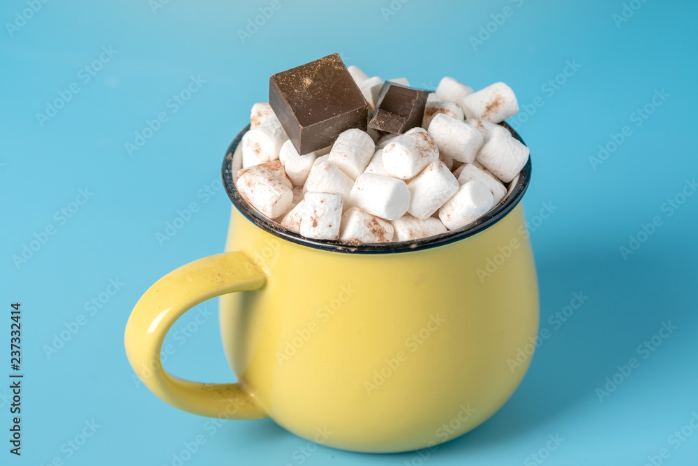 Mug of hot chocolate with marshmallows on top on a blue background. Cozy winter card Mug of hot chocolate with marshmallows on top on a blue background. Cozy winter card