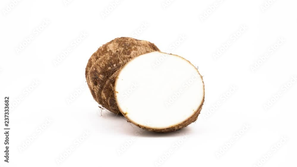 Two halves of taro root. Rotating on the turntable. Isolated on the white background. Close-up. Macro. Two halves of taro root. Rotating on the turntable. Isolated on the white background. Close-up. Macro.