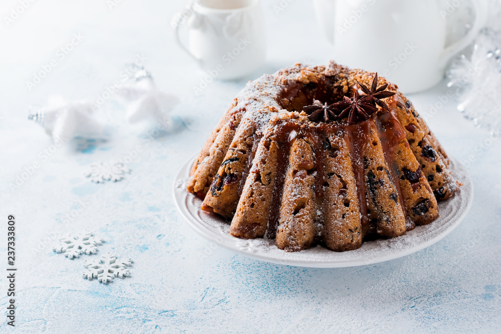 Traditional Christmas fruit cake, pudding on white plate. Top view. Copy space. Traditional Christmas fruit cake, pudding on white plate. Top view. Copy space.