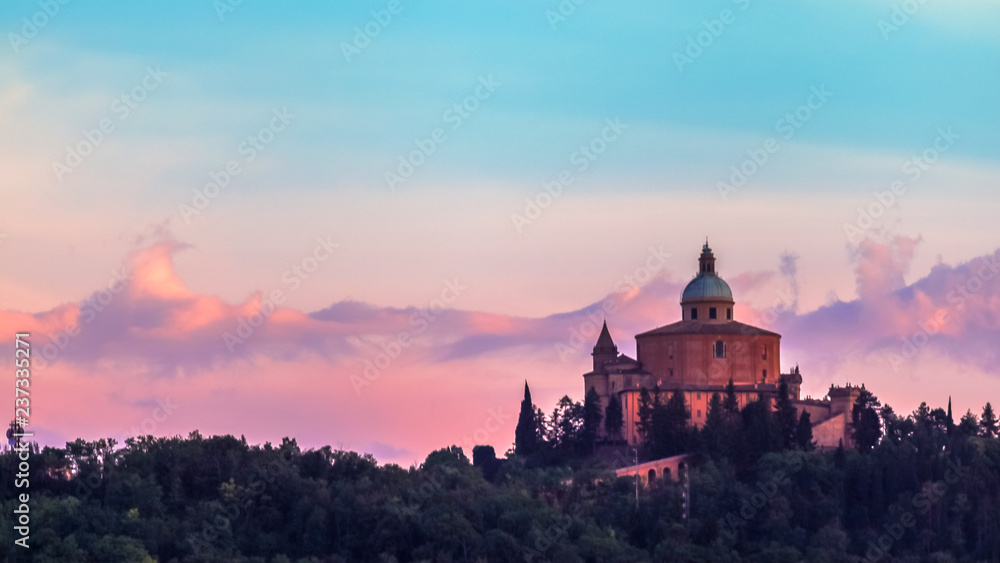 San Luca basilica church on Bologna hill, in a colorful twilight. pink and blue. in Italy