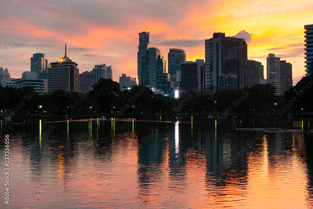 Fototapeta premium Bangkok city beautiful skyline at dusk, viewing from Lumphini Park with tourist are traveling here.