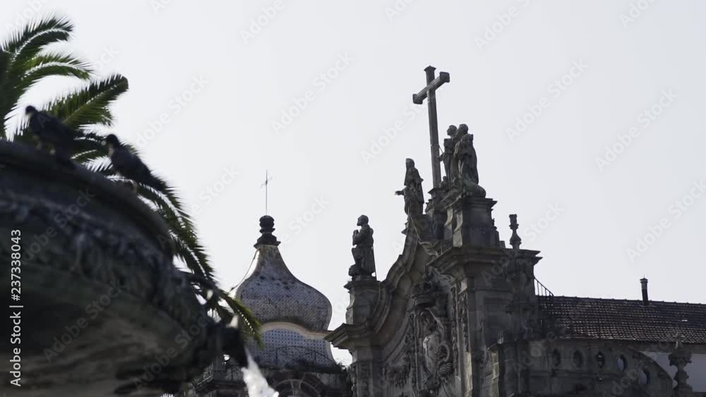 From below view facade of old cathedral with sculpture of saints at sky background old city centre Porto, Portugal From below view facade of old cathedral with sculpture of saints at sky background old city centre Porto, Portugal