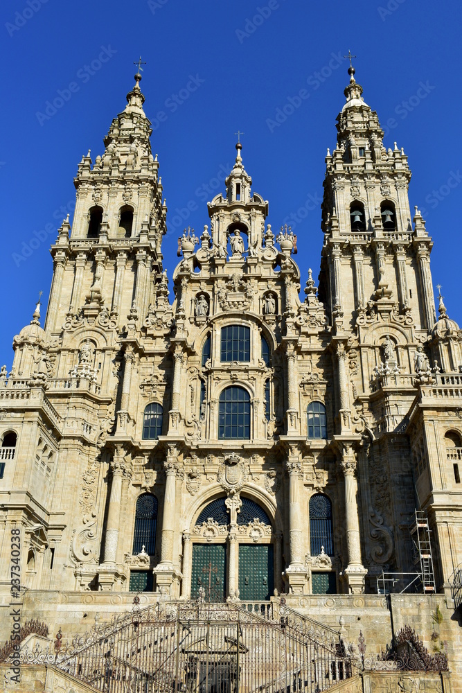 Cathedral, Santiago de Compostela, Obradoiro Square. Spain. Baroque facade, old iron gate and towers. Clean stone, sunny day.