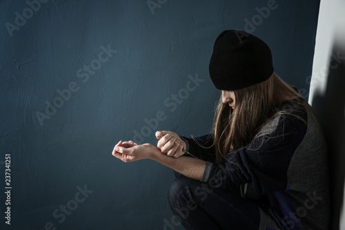 Female junkie with syringe ...