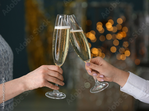 Friends clinking glasses with champagne at party