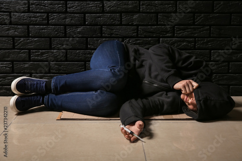 Female junkie with syringe ...