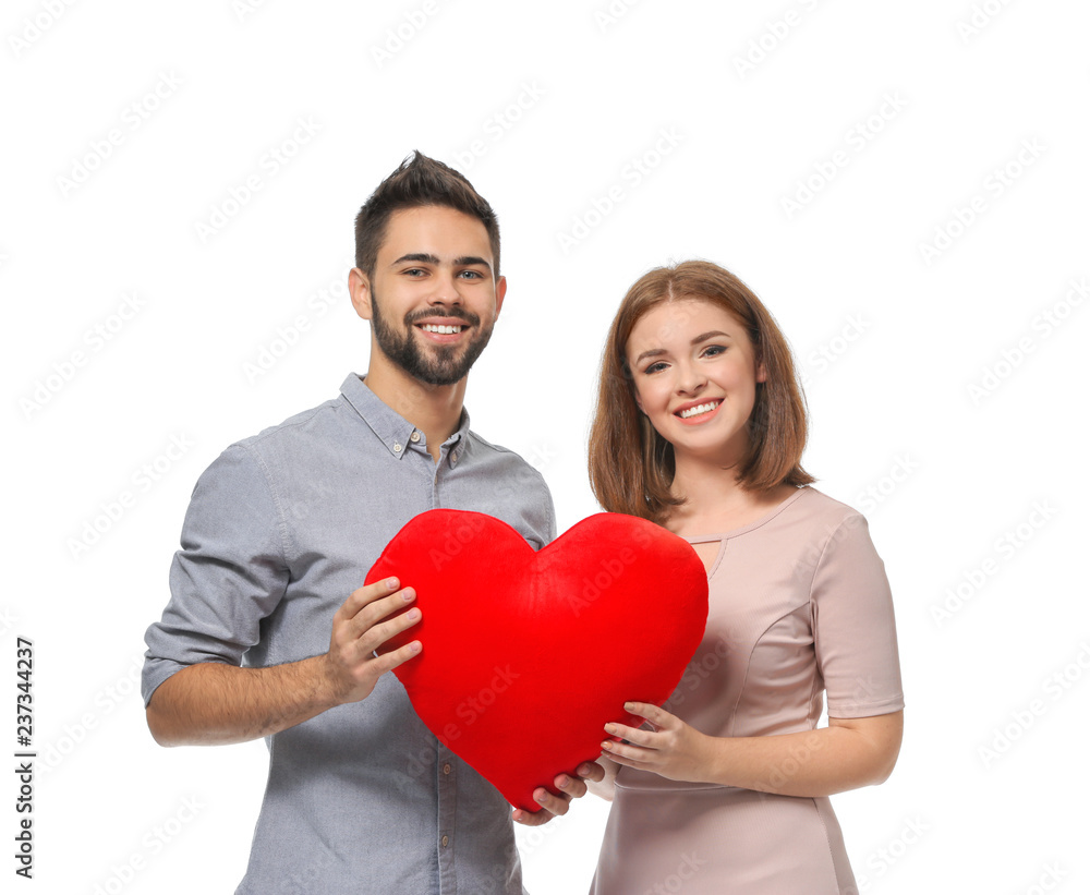Loving young couple holding fabric heart on white background. Celebration of Saint Valentine's Day Loving young couple holding fabric heart on white background. Celebration of Saint Valentine's Day