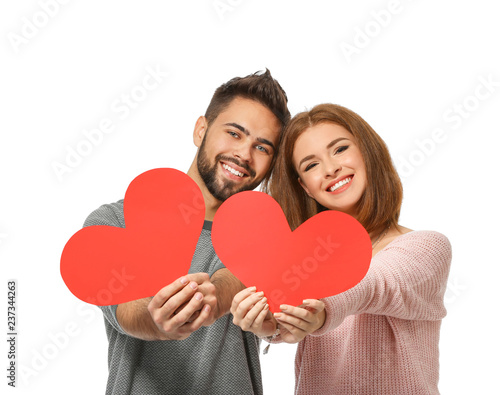 Loving young couple with paper red hearts on white background. Celebration of Saint Valentine's Day