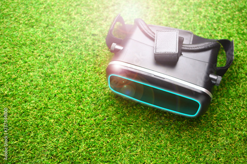 Vr glasses headset on a green grass. Virtual reality helmet.
