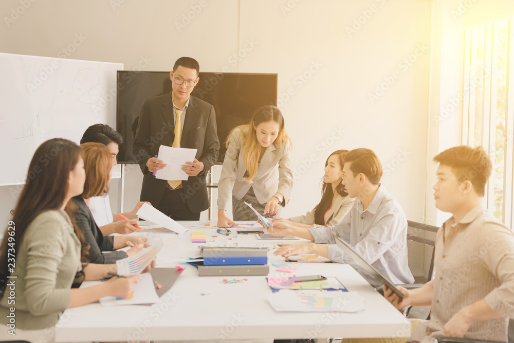 A group of Asian businessmen are discussing.The president and secretary Presentations to the employees. A group of Asian businessmen are discussing.The president and secretary Presentations to the employees.
