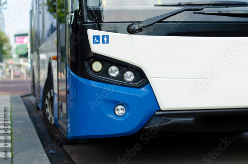 blue and white bus at the bus stop
