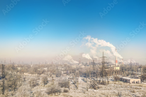 Panoramic view of city industrial area with many smoking stacks and pipes of plants and factories. Environmental pollution concept