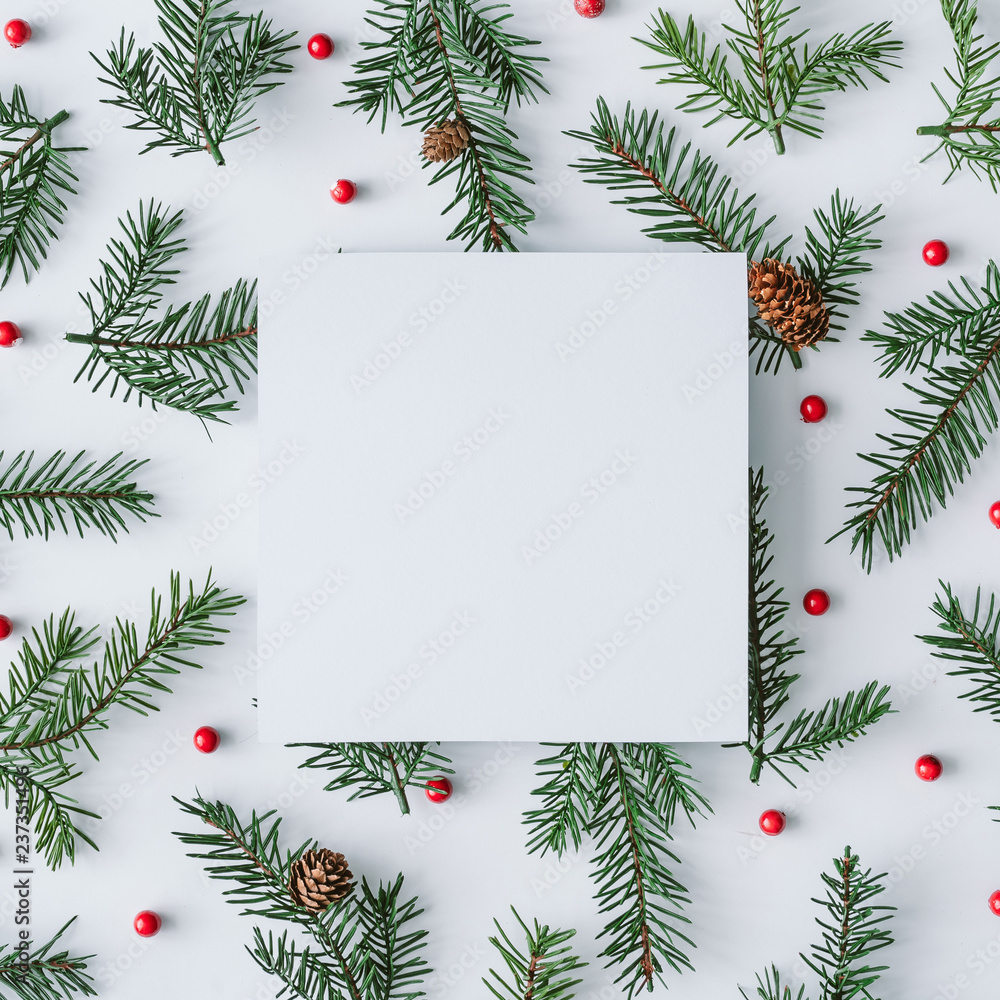 Fir branches with red berries background pattern. Winter flat lay composition. Top view. Fir branches with red berries background pattern. Winter flat lay composition. Top view.