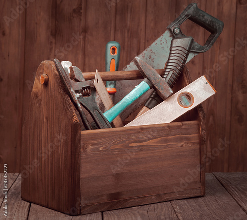 grungy old tools on a wooden background front view.