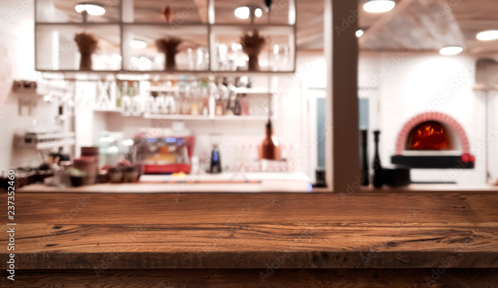 Table counter on blurred interior of rustic style restaurant kitchen