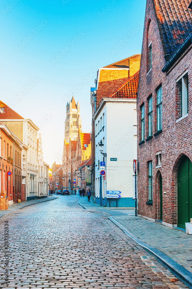 Picturesque narrow Brugge street at early sunny morning