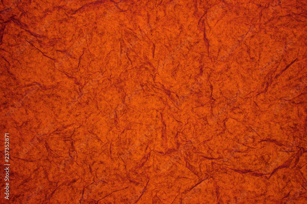 ABSTRACT RANDOM BACKGROUND OF CREASED CRUMPLED DARK ORANGE DARK ORANGE TISSUE PAPER