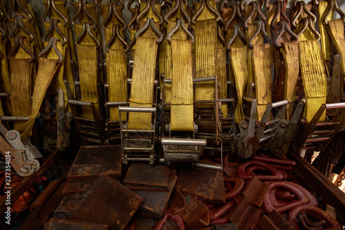 Plenty of polyester webbing lashing, lashing belts, straps and ratchets stowed in lashing container. Background. photo