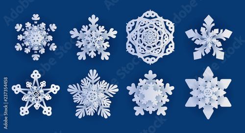Vector set of 8 white Christmas paper cut template snowflakes with shadow on blue background. New year design elements