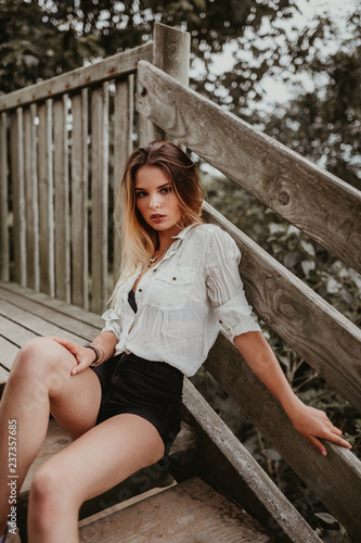 Young woman sitting on wooden steps