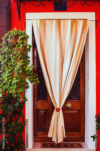 Picturesque door in Burano, the lagoon island of Venice in Italy photo