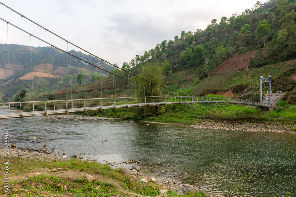 Metal hanging bridge over a river Vietnam
