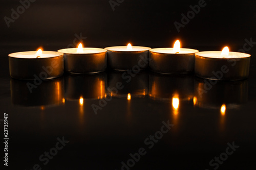 candles in the dark with reflection