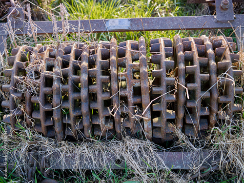 Farm implements: Closeup of a segment of an old and rusty Cambridge roller photo