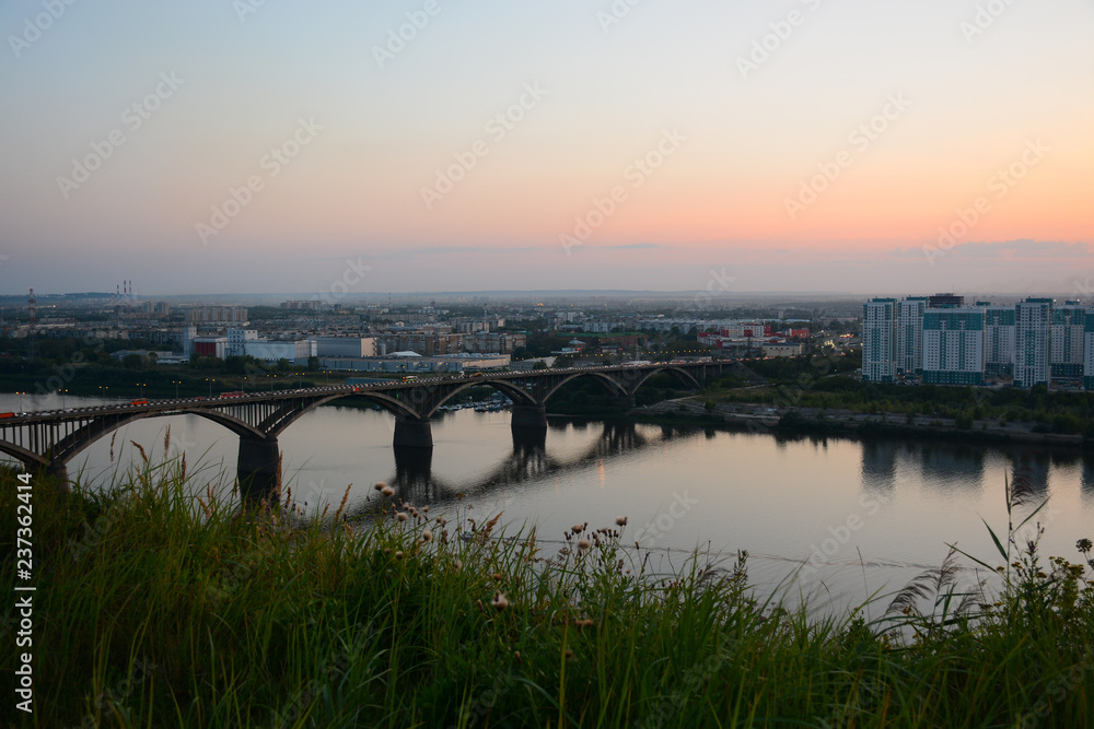 NIZHNY NOVGOROD, RUSSIA - AUGUST 28, 2018: View to Okskiy Bridge and lower city from Okskiy Syezd at time of sunset
