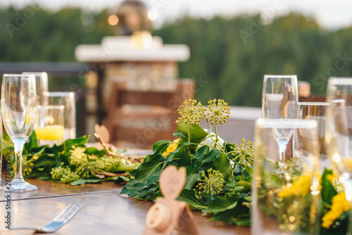 Table set up for a special event/wedding. Yellow and green fresh flowers