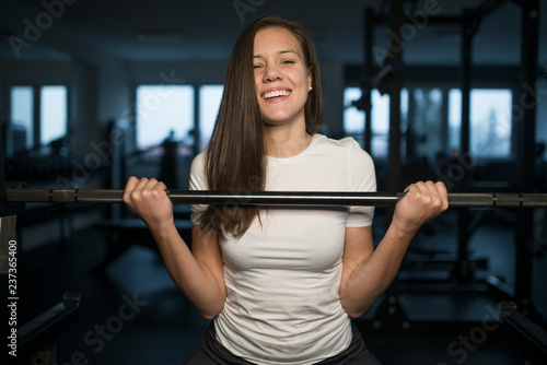 Smiling beautiful female doing her training in the gym