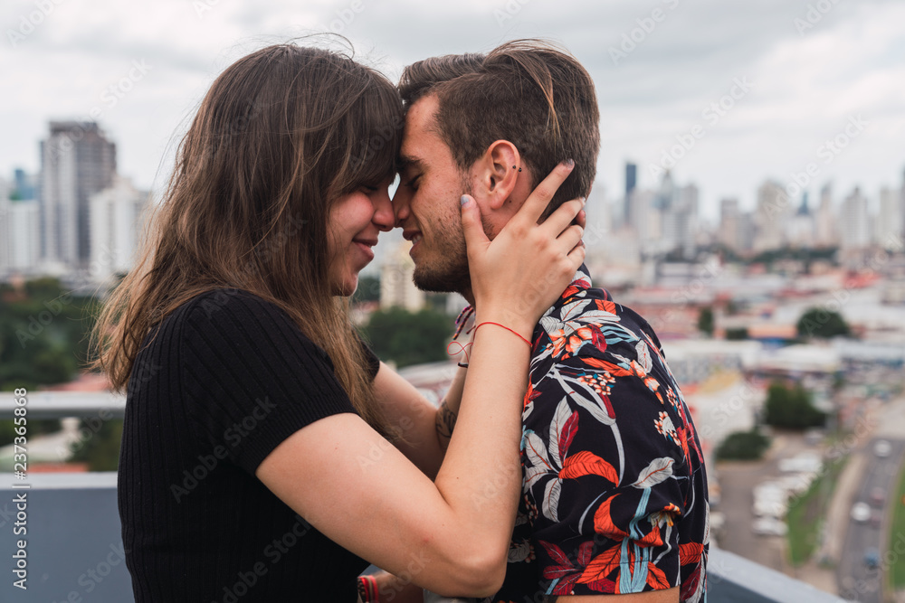 Cute couple touching noses on balcony Cute couple touching noses on balcony
