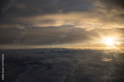 Sun over the clouds during a flight