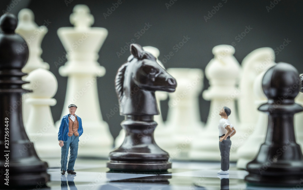 Man thumbnail within a game of chess, concept Man thumbnail within a game of chess, concept