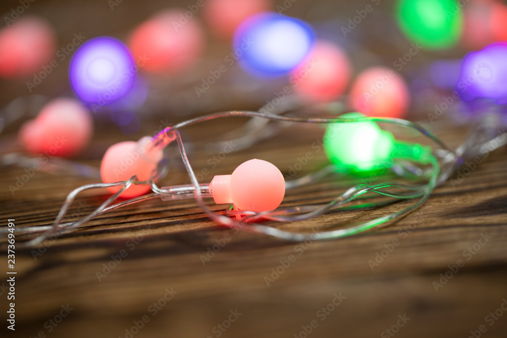 Christmas lights on dark blue background with copy space. Decorative garland