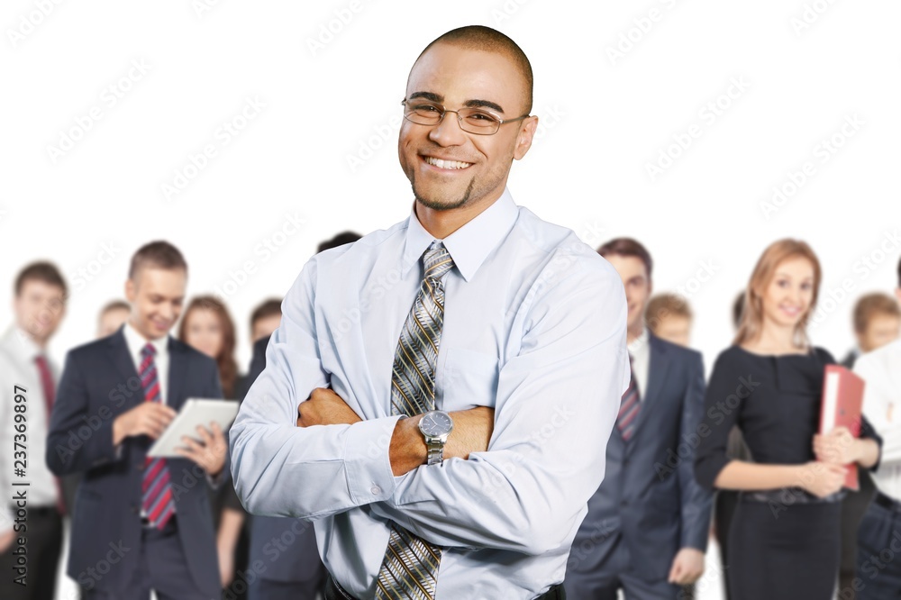 Smiling handsome businessman with crossed hands isolated on Smiling handsome businessman with crossed hands isolated on