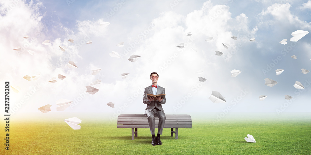 Young businessman or student studying the science and paper planes fly around Young businessman or student studying the science and paper planes fly around