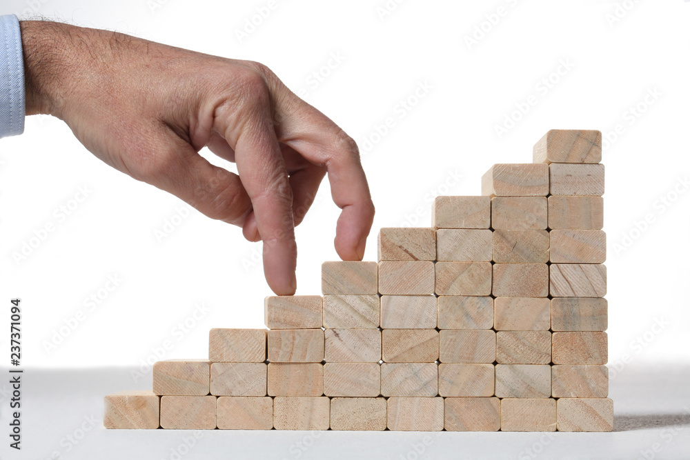 stairs build with wooden blocks on grey background stairs build with wooden blocks on grey background