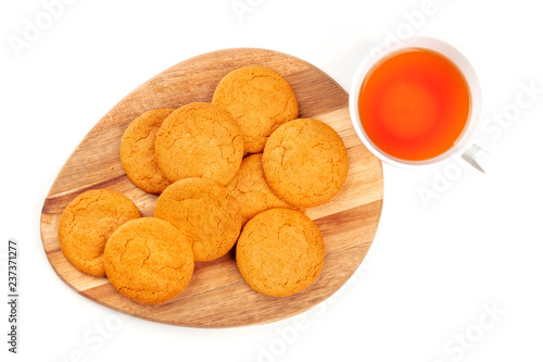 A photo of ginger cookies with a cup of tea, shot from the top on a white background with a place for text