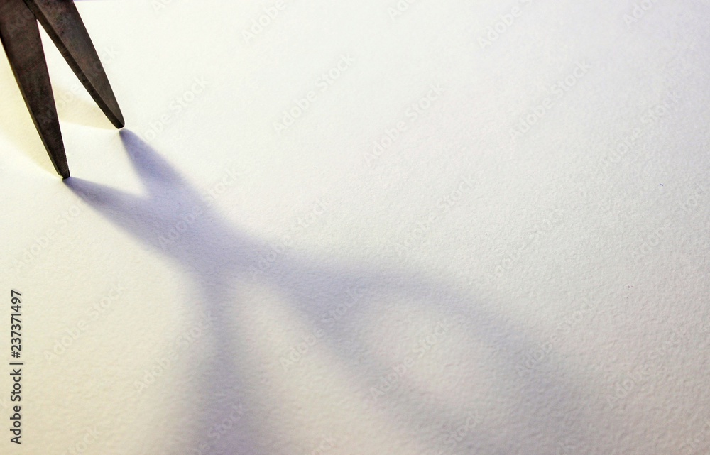 scissors shadow on paper, soft focus scissors shadow on paper, soft focus