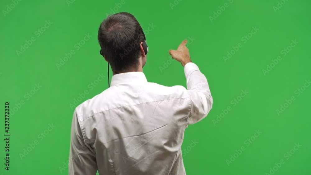 telemarketer man pointing back with the index finger on green screen chroma key background telemarketer man pointing back with the index finger on green screen chroma key background