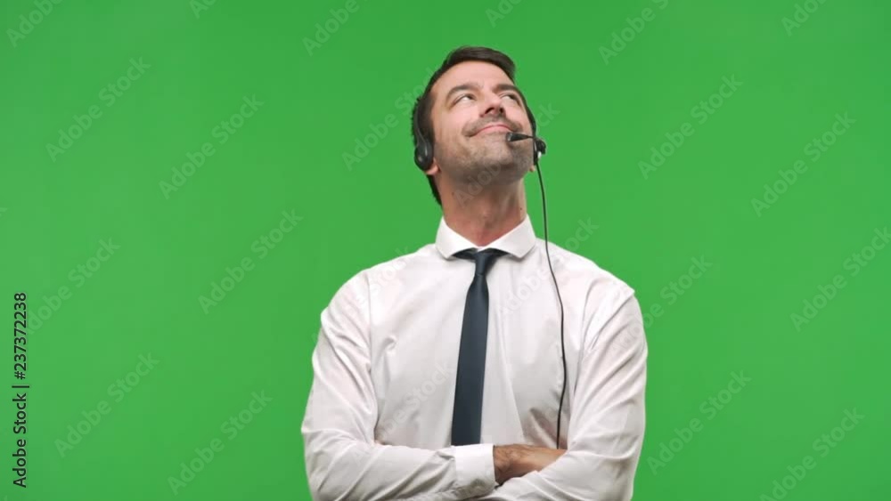 telemarketer man looking up on green screen chroma key background telemarketer man looking up on green screen chroma key background